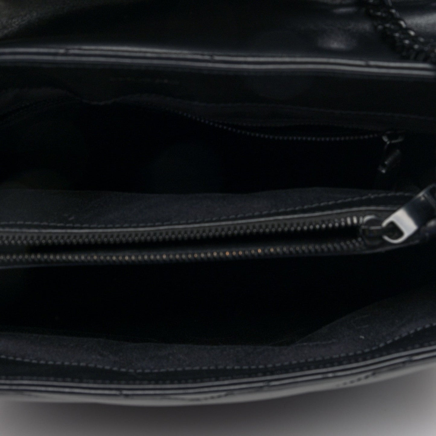 Black satchel interior with zip closure and metal zipper pull