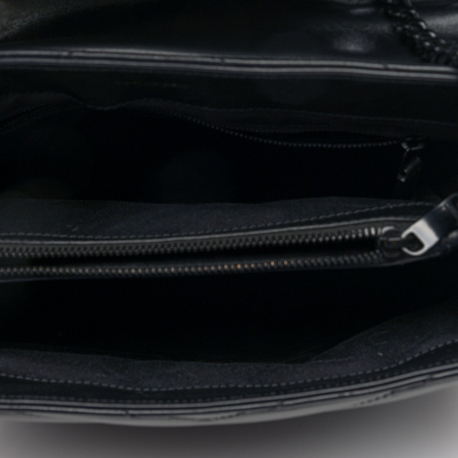 Black satchel interior with zip closure and metal zipper pull