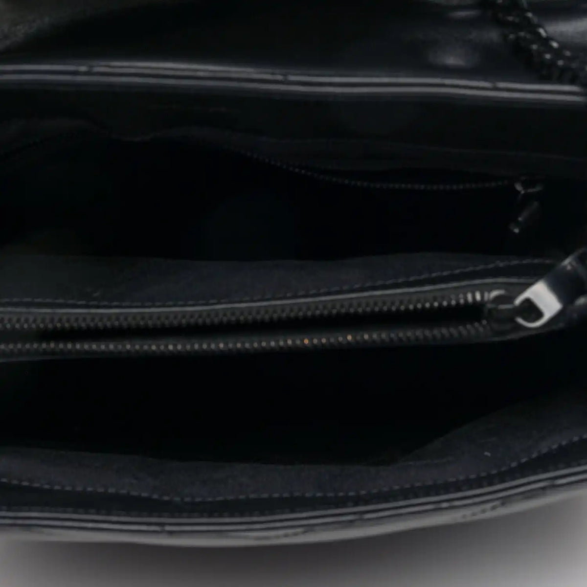 Black satchel interior with zip closure and metal zipper pull