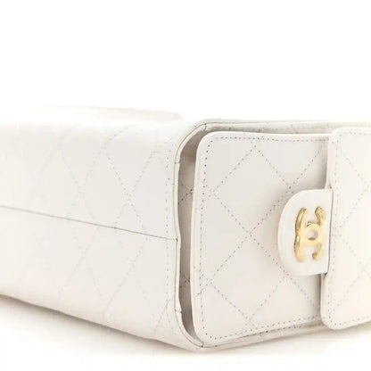Pristine white mini handbag corner view with quilted texture and CC turn-lock clasp