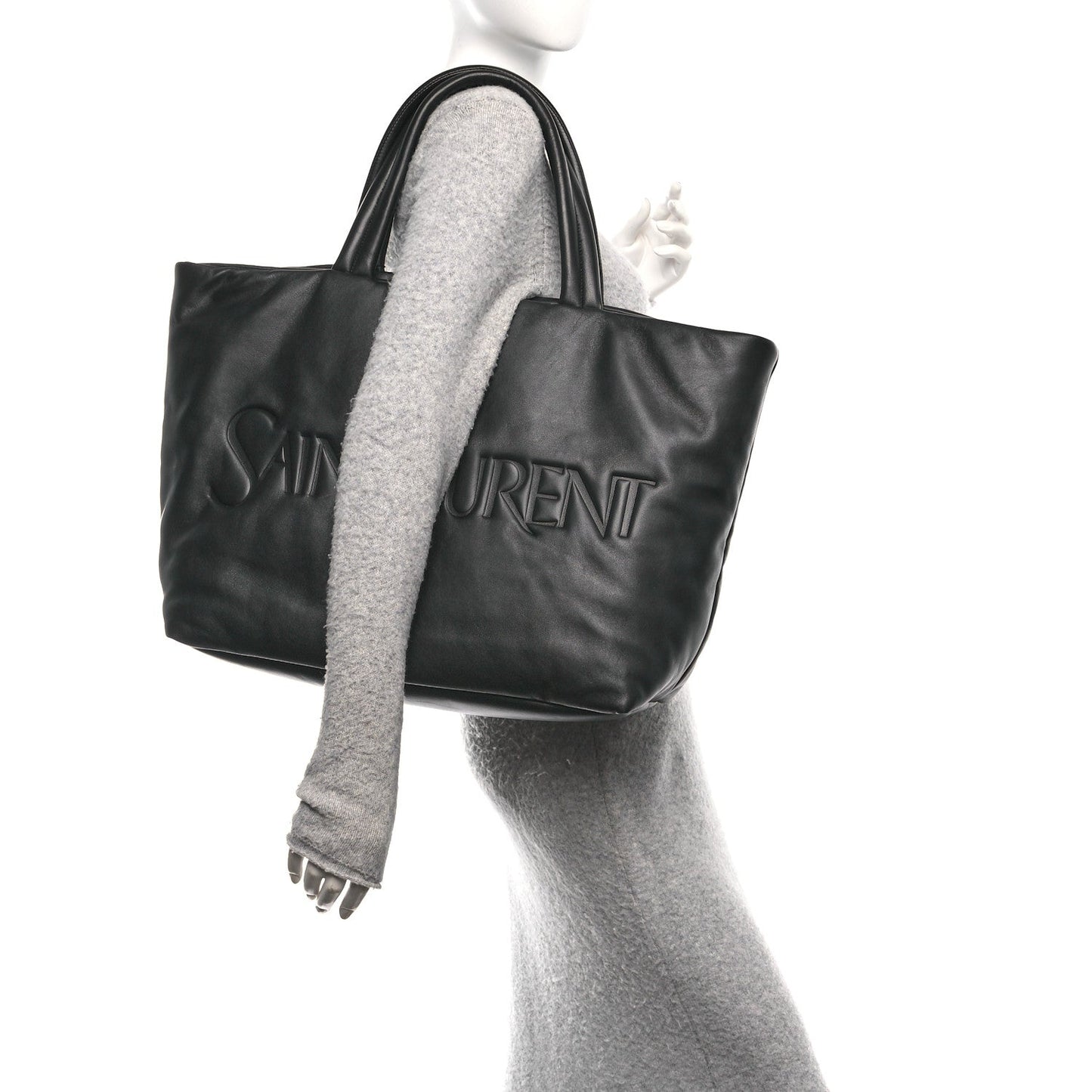 Black lambskin wide puffer tote with embossed logo, top handles, and side view.