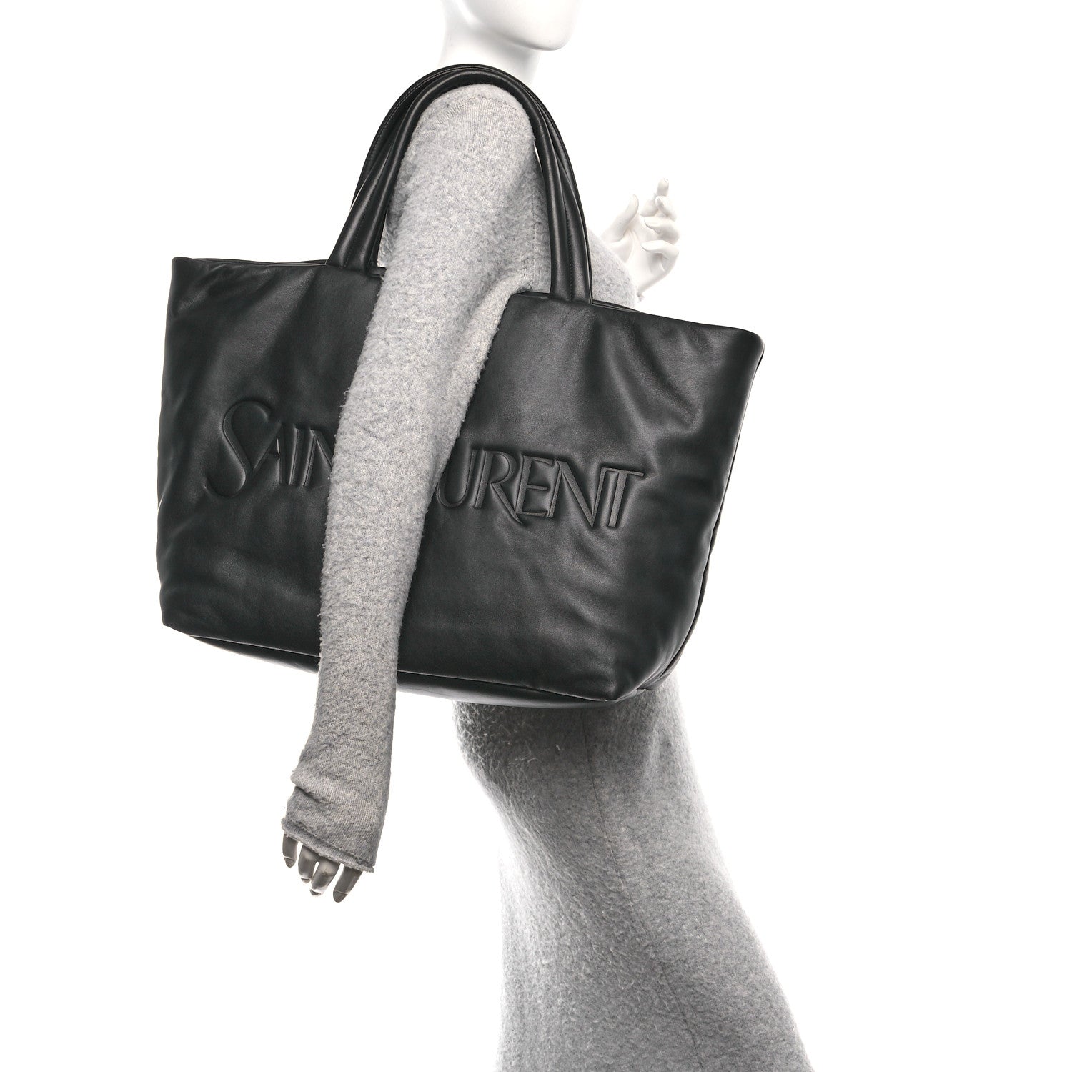 Black lambskin wide puffer tote with embossed logo, top handles, and side view.