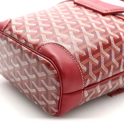 Corner of red mini handbag with Goyardine pattern and curved leather trim