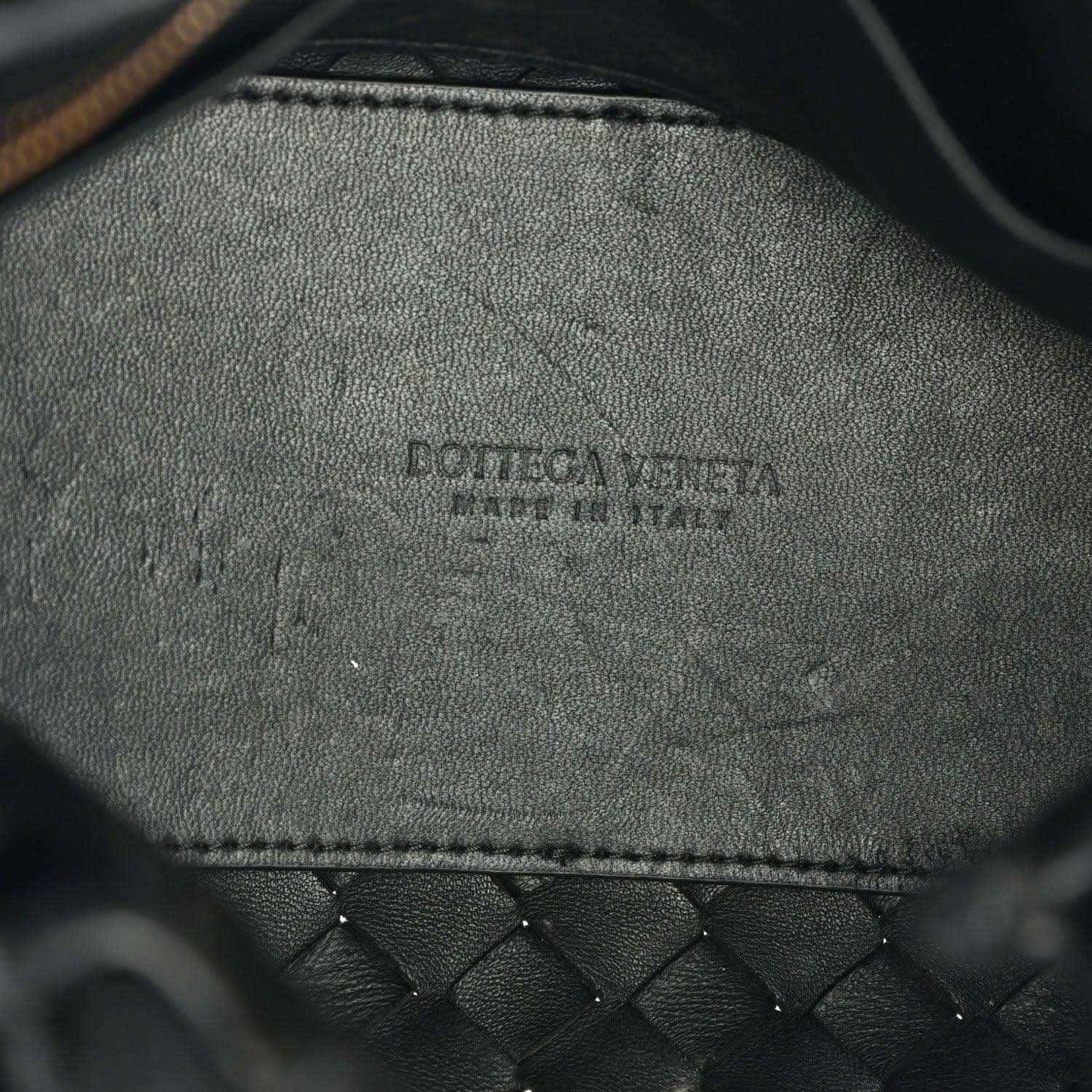 Black leather interior with embossed brand logo and stitched edge