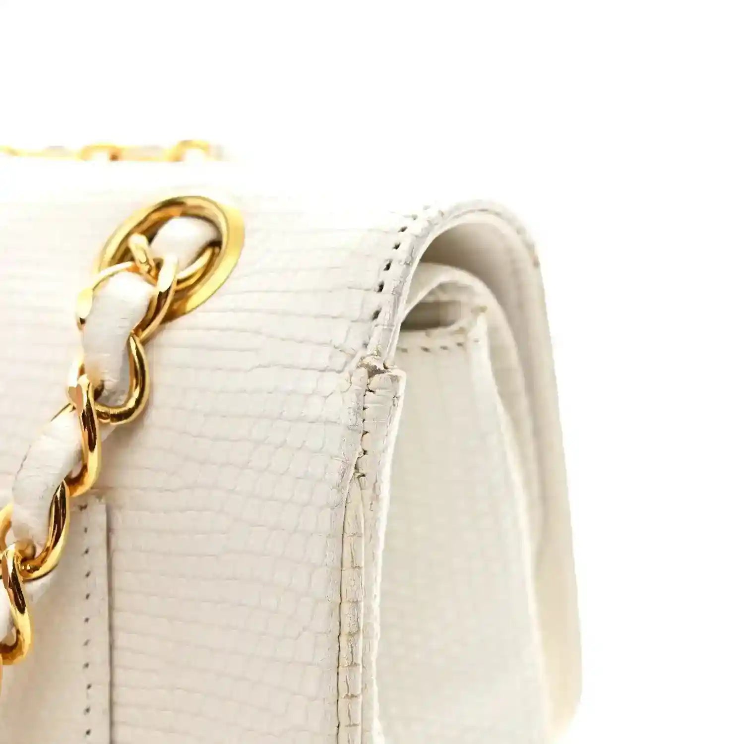 Small double flap bag with gold chain on white textured lizard leather