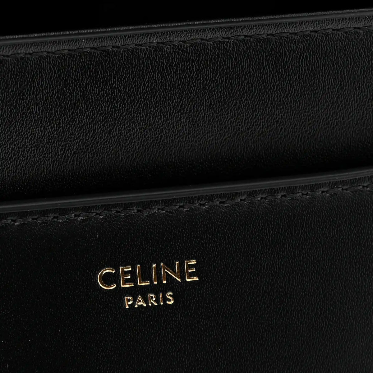 Black leather with CELINE PARIS embossed branding and subtle stitching detail