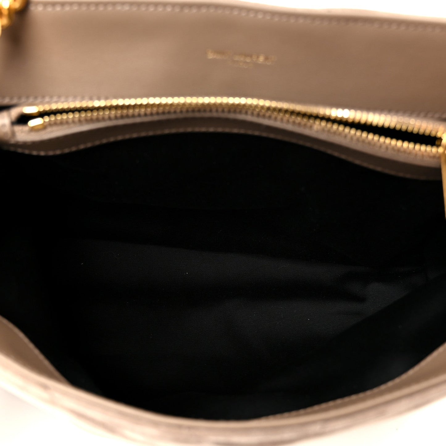 Satchel interior lining with visible gold zipper trim