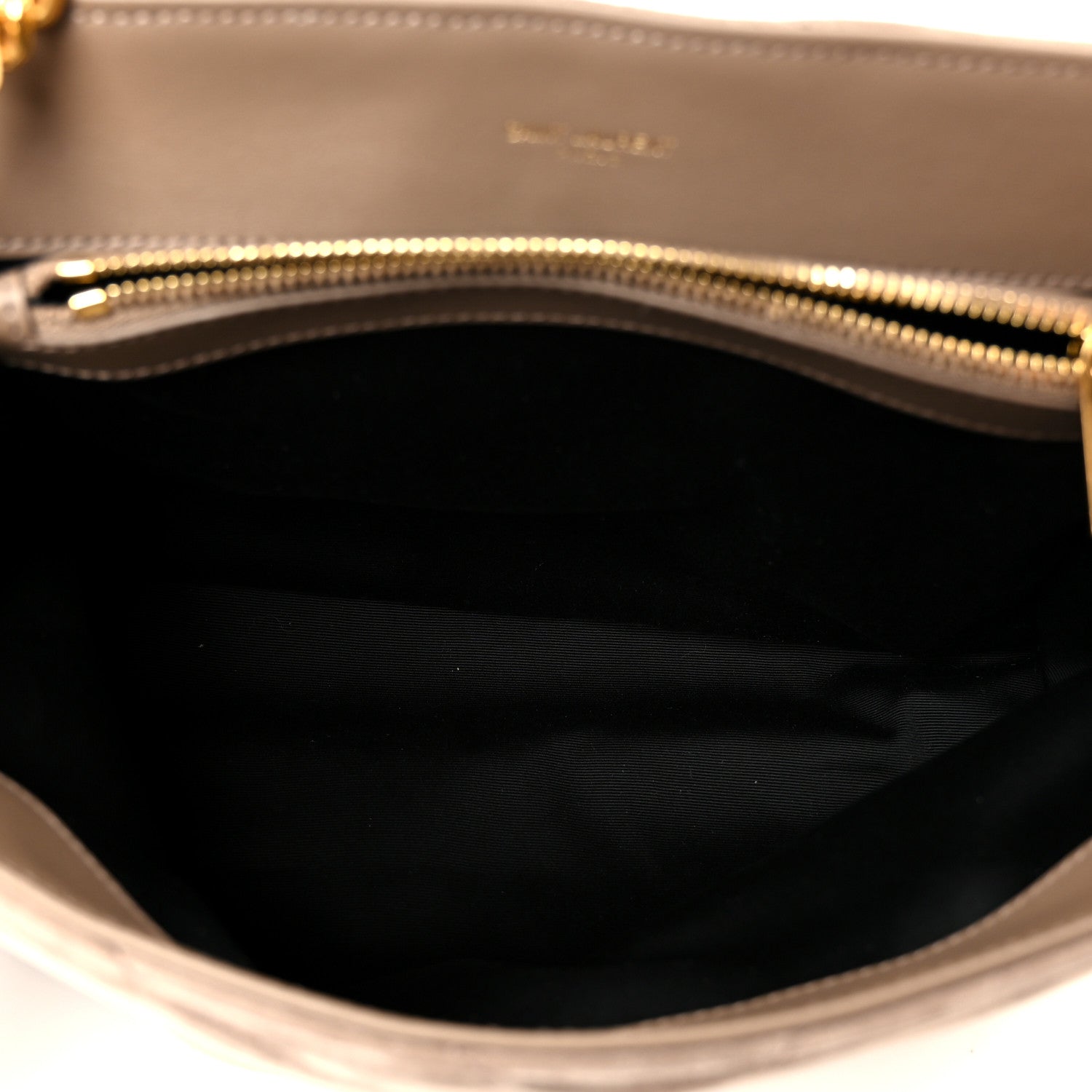 Satchel interior lining with visible gold zipper trim