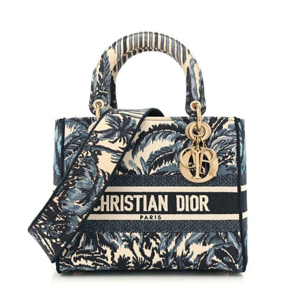 Medium tote bag with blue palm toile print, navy trim, top handles, and gold Dior charm