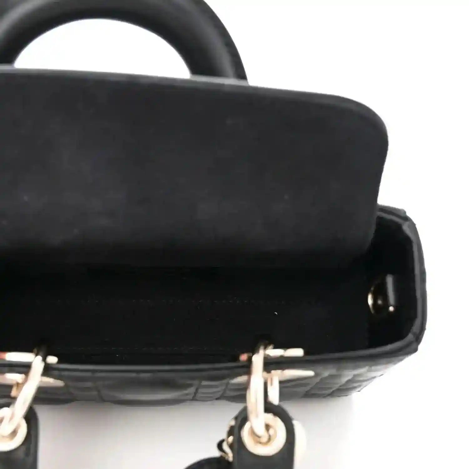 Black lambskin handbag with gold hardware and smooth trim, close-up