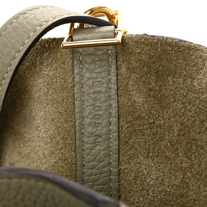 Sauge leather tote bag close-up of gold top hardware and strap stitching