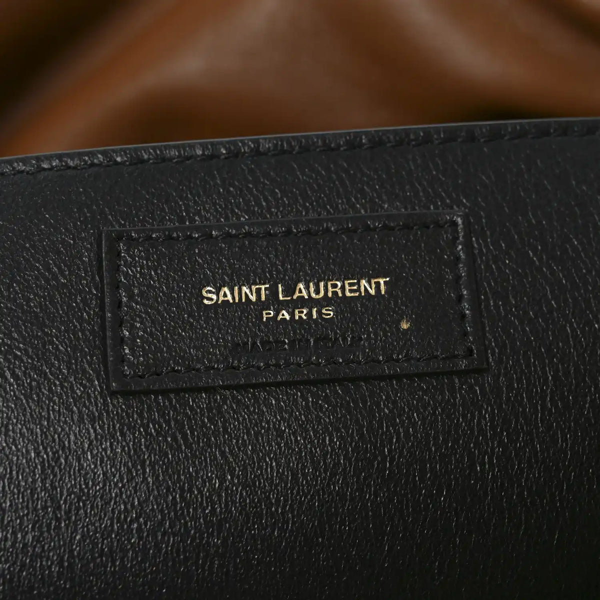 Black leather interior patch label reading SAINT LAURENT PARIS on shoulder bag