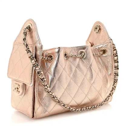 Copper quilted mini Chanel-style handbag with chain strap and front clasp hardware.