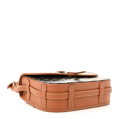 Monogram mini messenger bag with tan leather base, strap loops, and dark patterned top