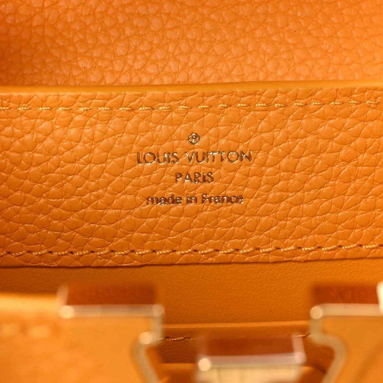 Louis Vuitton leather handbag in yellow with embossed 'Louis Vuitton Paris' on lining
