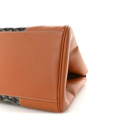 Goyard Saigon tote handbag corner close-up with tan leather side and monogram base