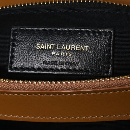 Black leather brand label on satchel interior, with SAINT LAURENT PARIS and MADE IN ITALY