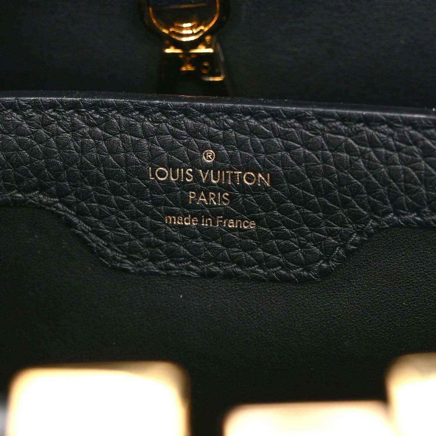 Black Louis Vuitton handbag interior stamp reading “Louis Vuitton Paris made in France”