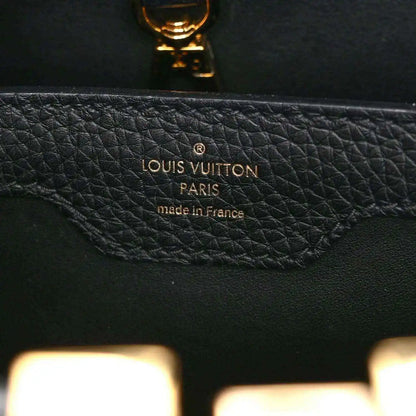 Black Louis Vuitton handbag interior stamp reading “Louis Vuitton Paris made in France”