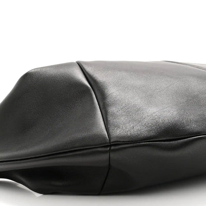 Black lambskin hobo bag panel and crease detail near the top seam