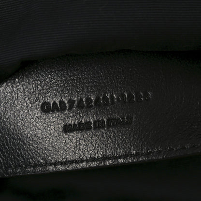 Embossed text on black leather interior of shoulder bag, includes MADE in Italy