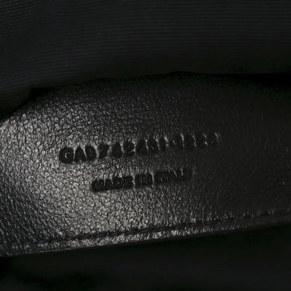 Embossed text on black leather interior of shoulder bag, includes MADE in Italy