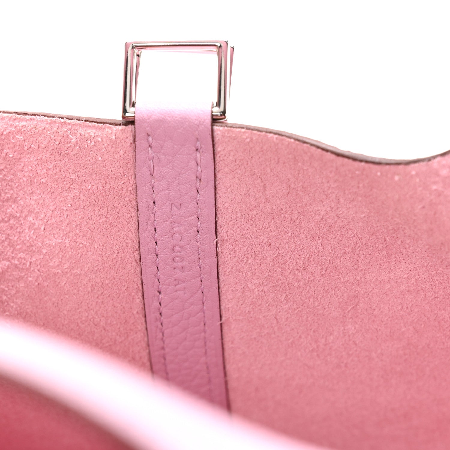 Rose pink handbag top hardware and stitched strap at foldover edge