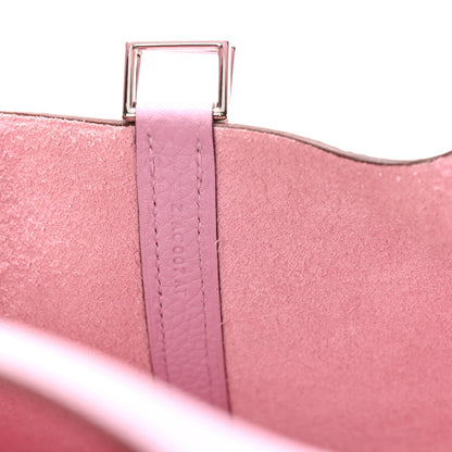 Rose pink handbag top hardware and stitched strap at foldover edge