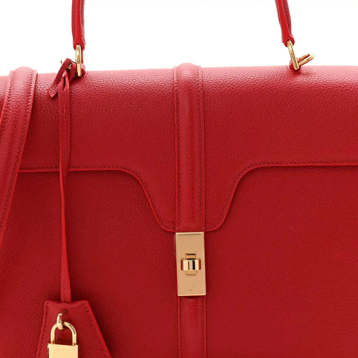 Red grained leather flap top with gold clasp and side pull tab