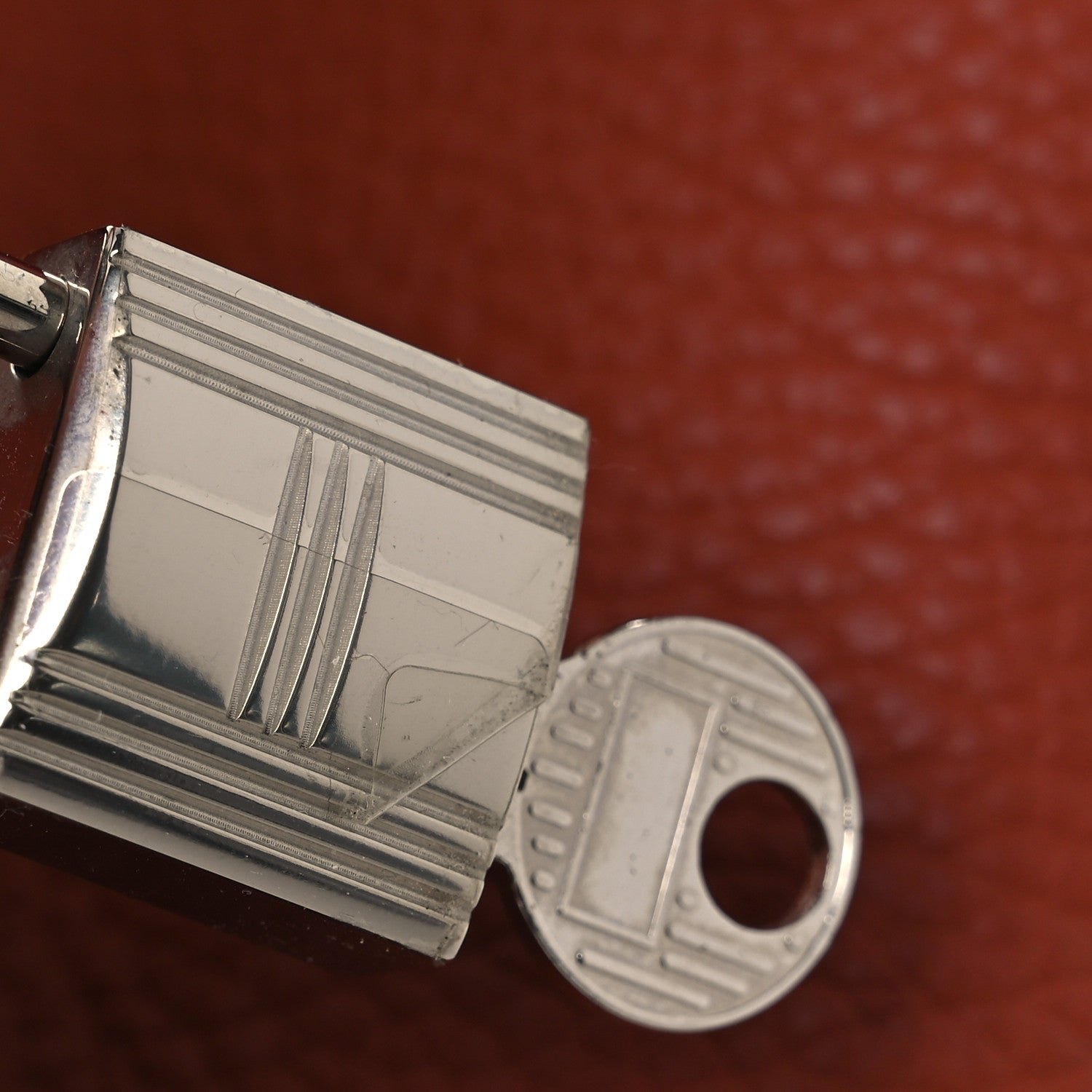 Leather tote clasp with engraved silver metal hardware and circular keyring detail