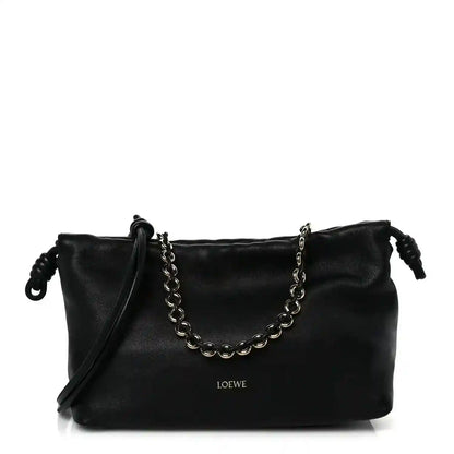 Black leather Flamenco-style clutch with chain strap and short shoulder drop handles.