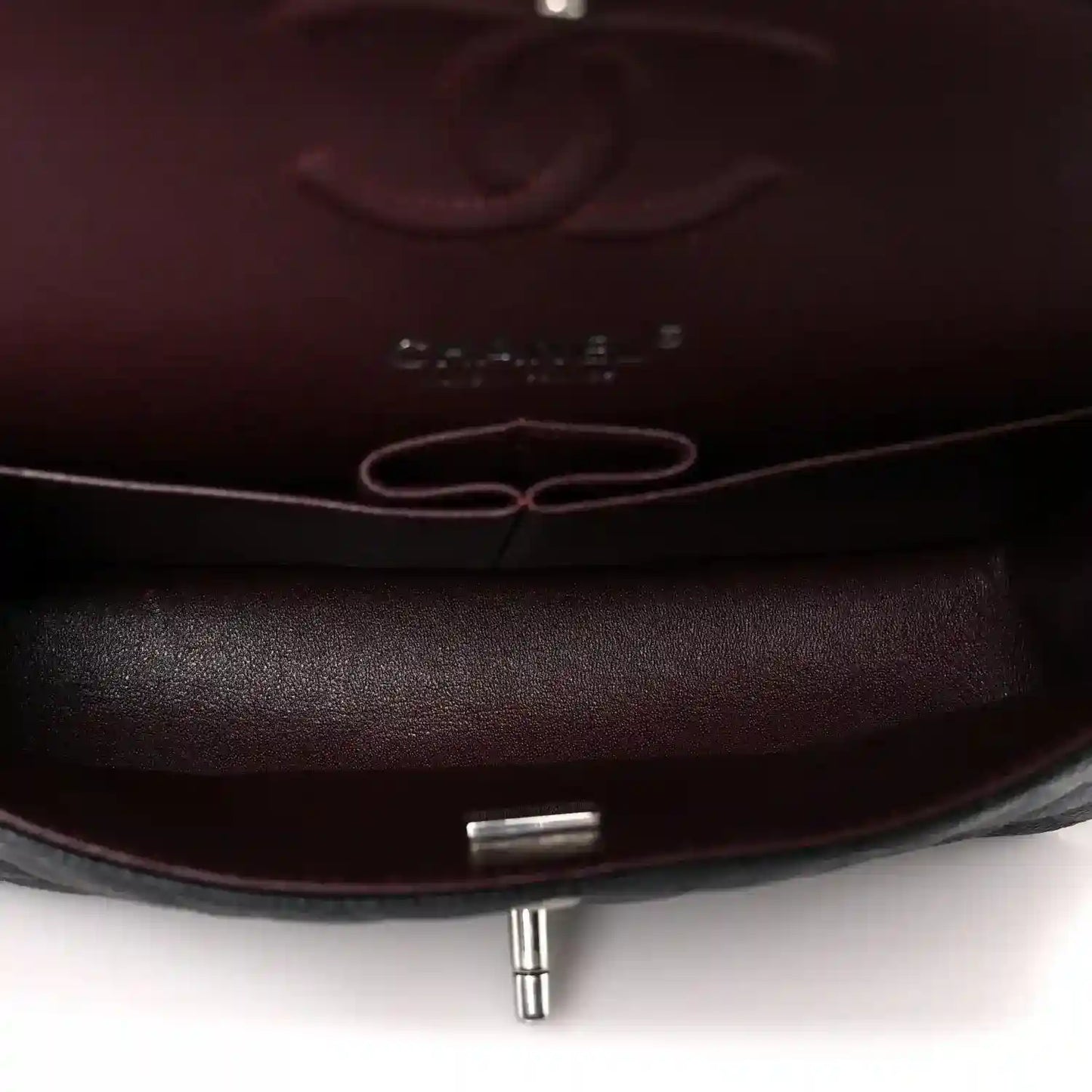 Flap bag interior lining with metal turn-lock post and stitched edges