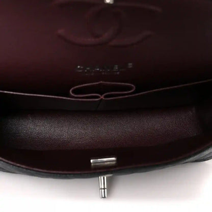 Flap bag interior lining with metal turn-lock post and stitched edges