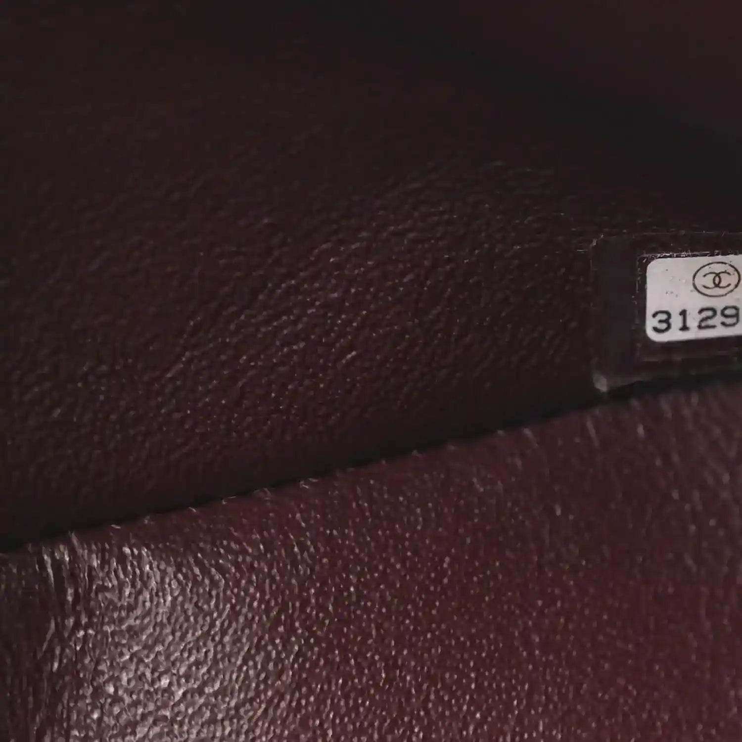 Chanel leather bag interior corner close-up with label tag and textured lining