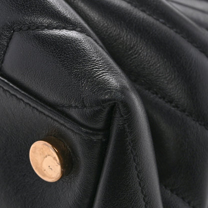 Black quilted leather satchel with gold-tone snap hardware