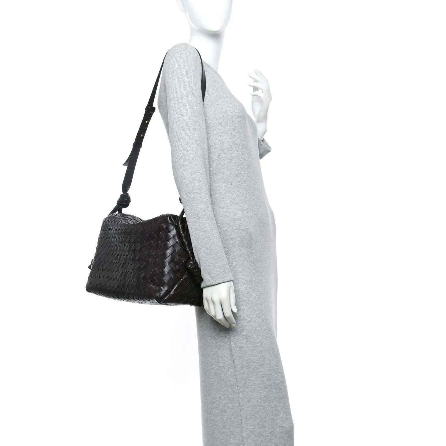Black woven leather weekender bag with adjustable shoulder strap and knotted cords