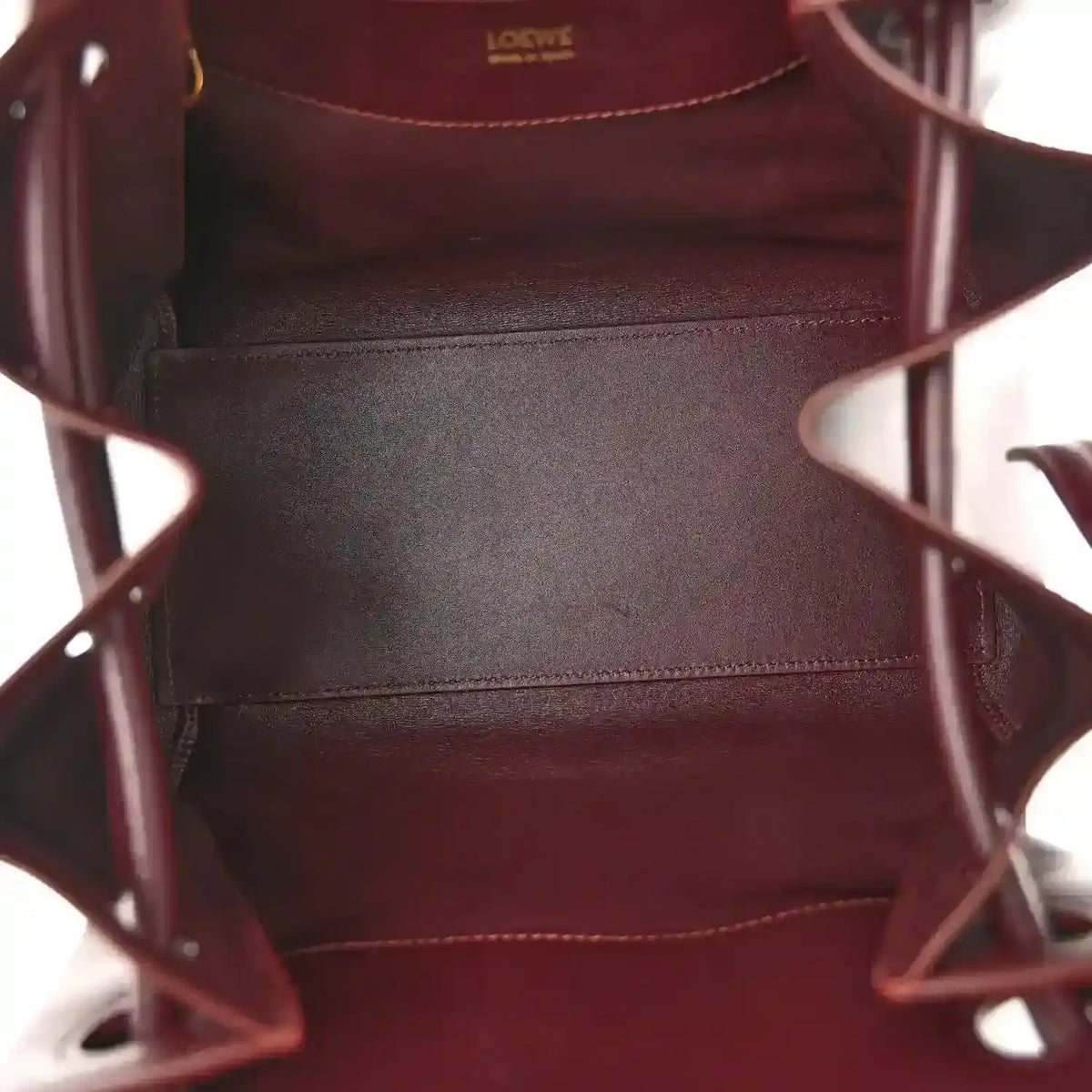 Loewe Small Madrid bag interior with burgundy leather lining and stitched seams