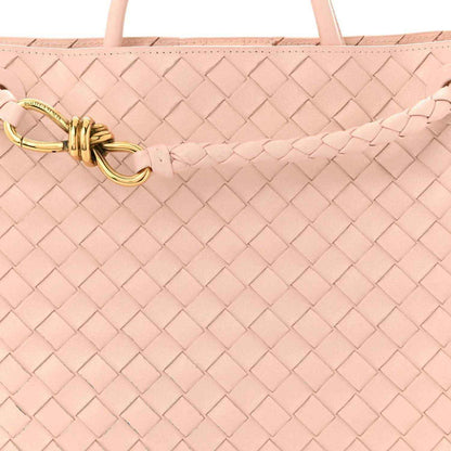 Pink intrecciato leather bag with gold toggle clasp on braided strap