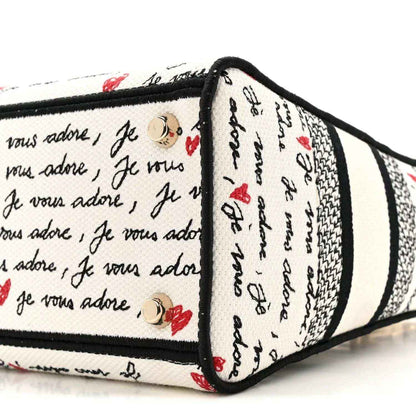 Christian Dior canvas handbag end panel with snap detail, “Je vous adore” print, red hearts