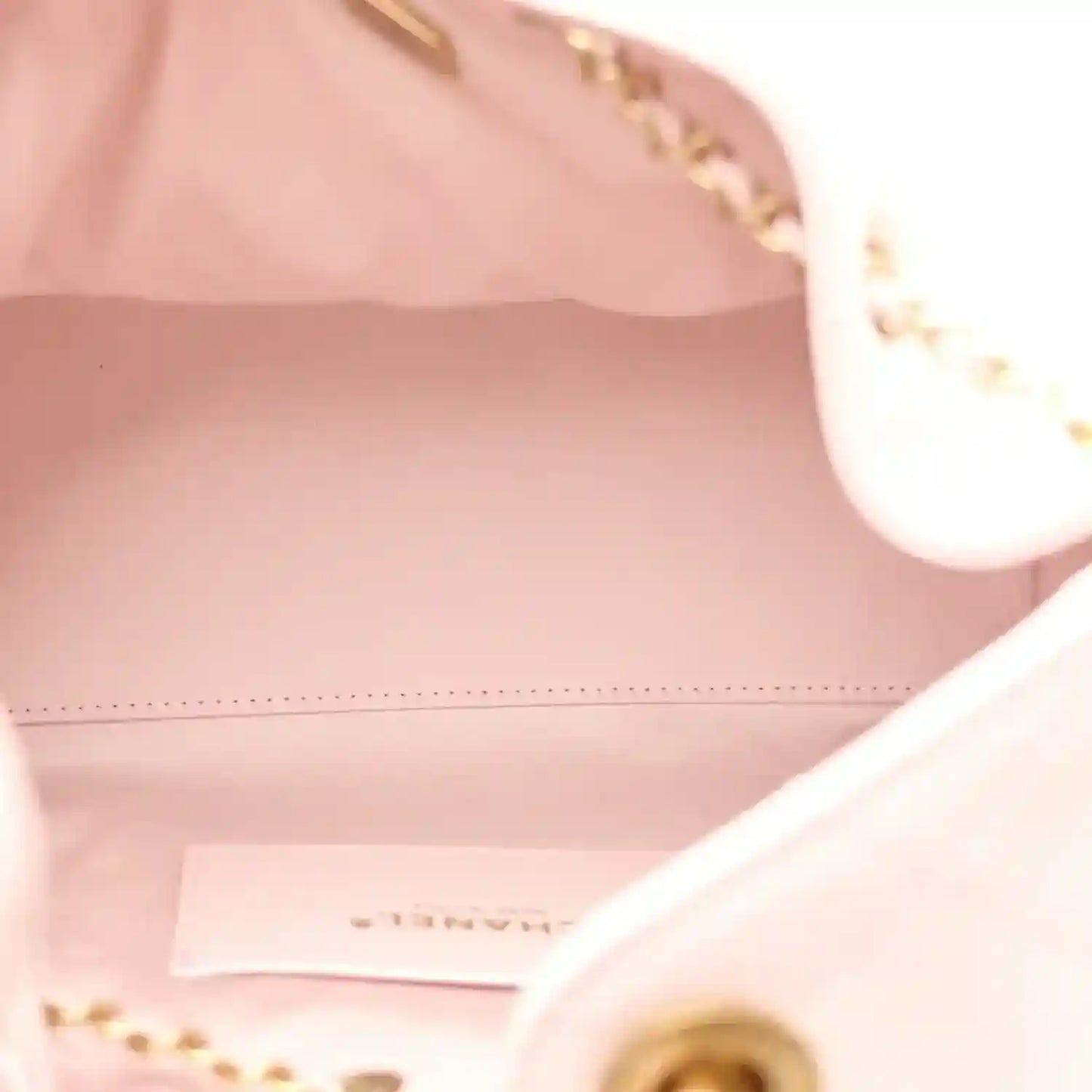 Chanel light pink handbag interior with stitched edge and gold hardware