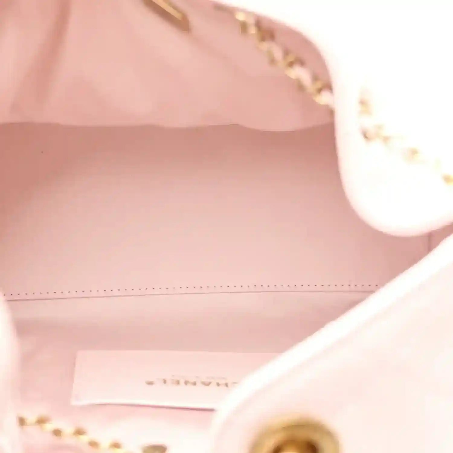 Chanel light pink handbag interior with stitched edge and gold hardware