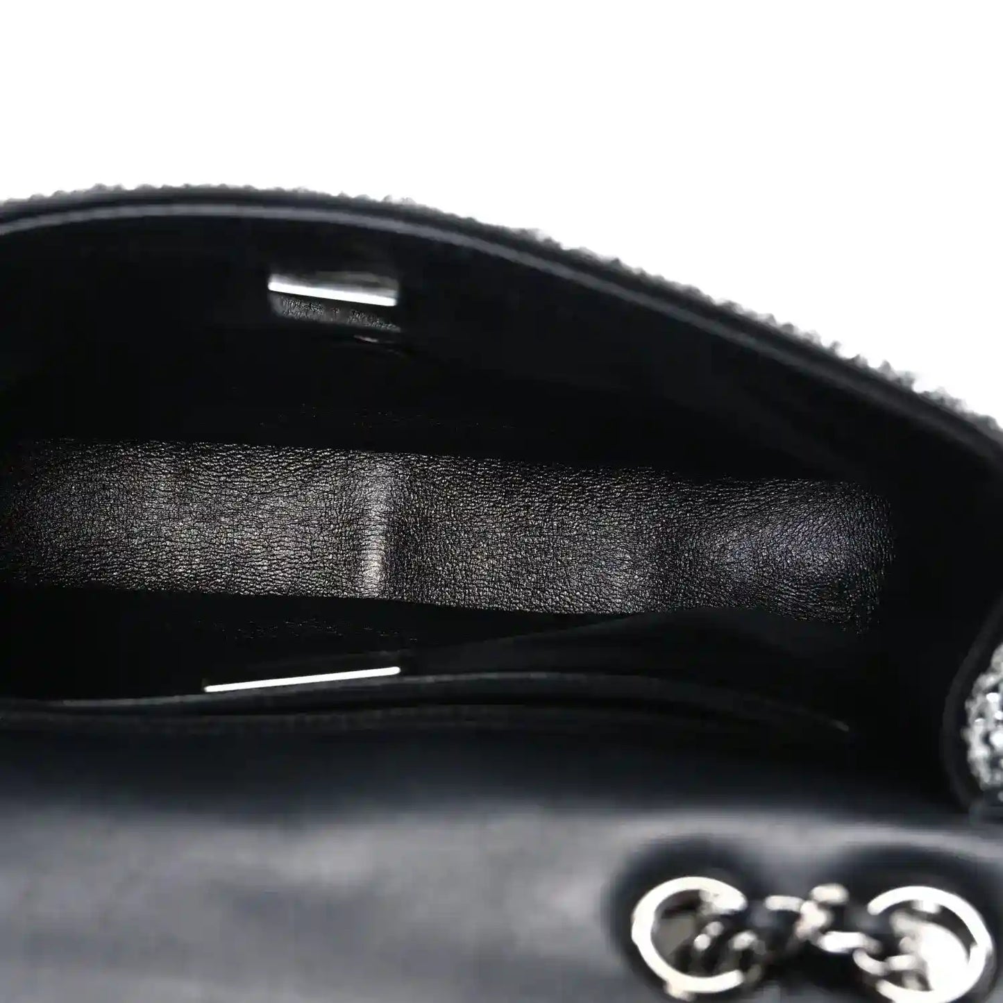 Black small flap bag interior with satin lining and metal frame opening
