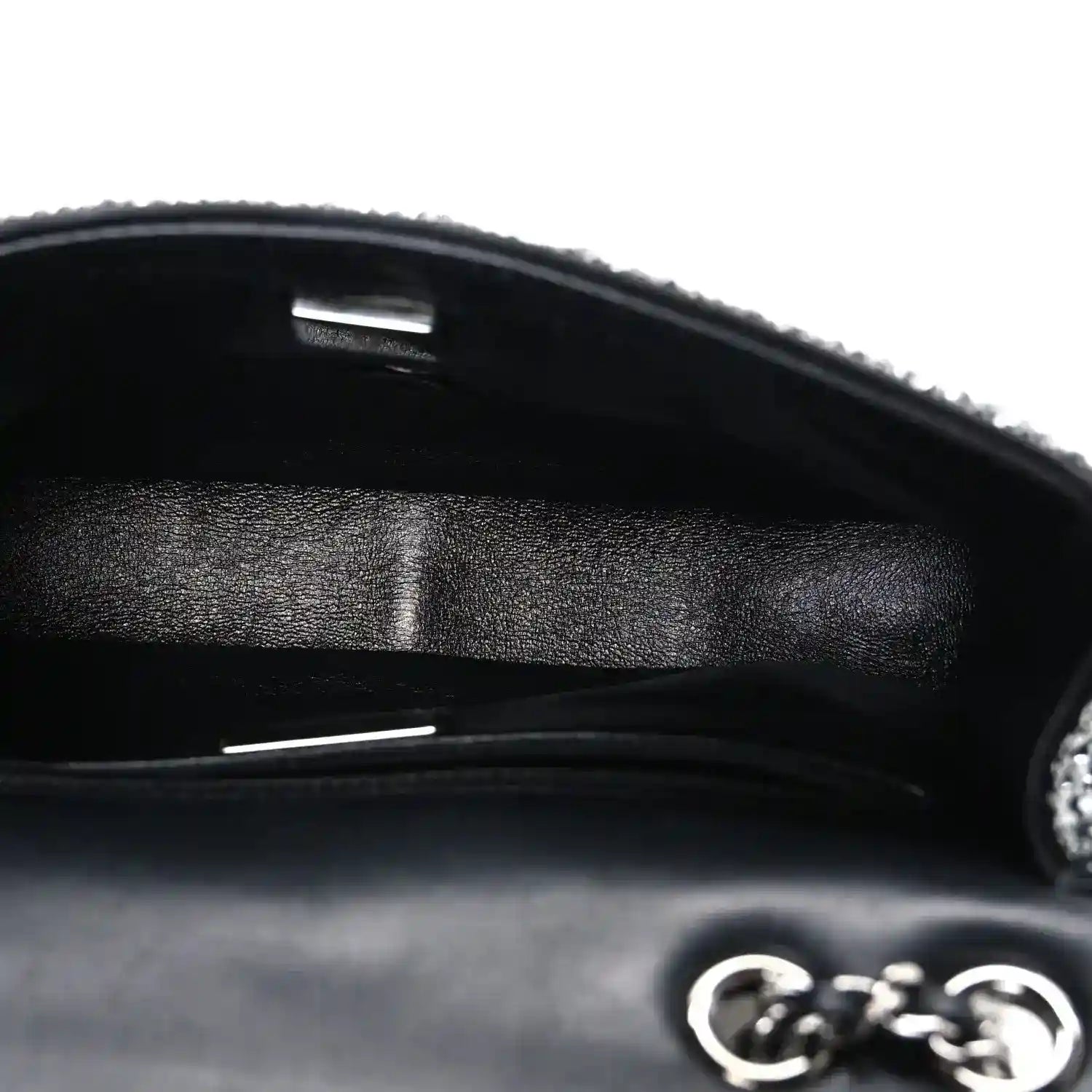 Black small flap bag interior with satin lining and metal frame opening
