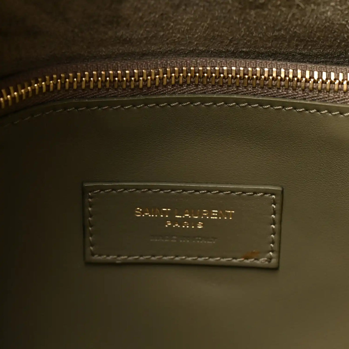 Saint Laurent Paris leather bag interior label with gold zipper