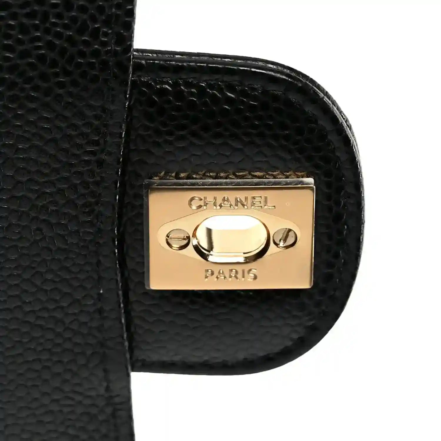 Chanel gold-tone hardware plate on black quilted leather flap edge