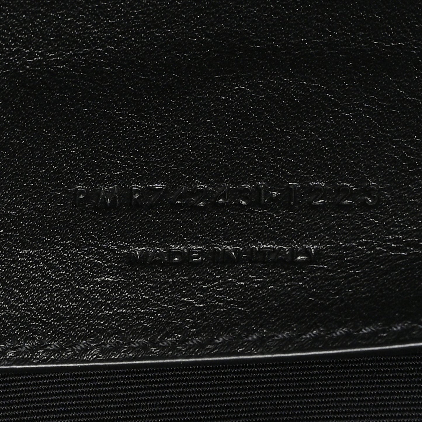 Leather brand stamp on black lining with SAINT LAURENT PARIS text