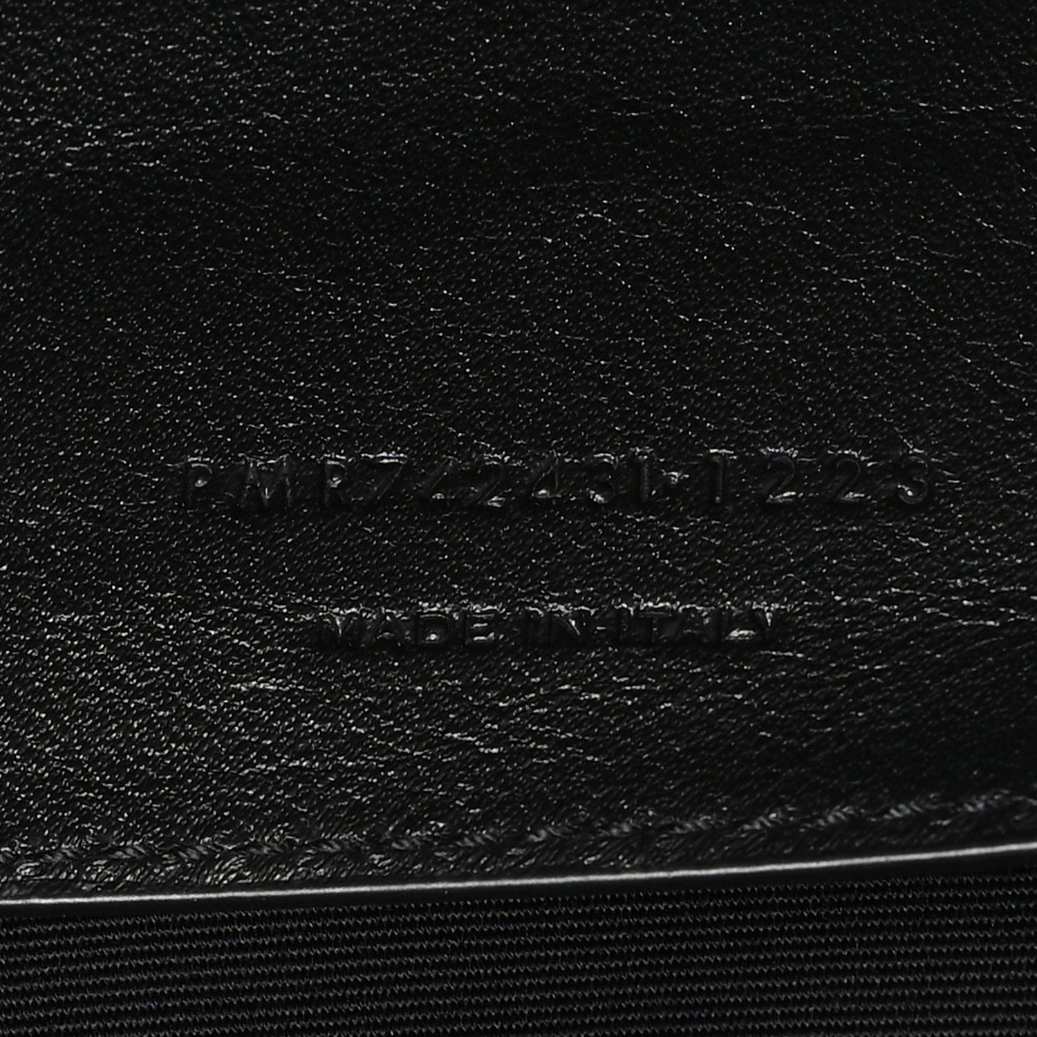 Leather brand stamp on black lining with SAINT LAURENT PARIS text
