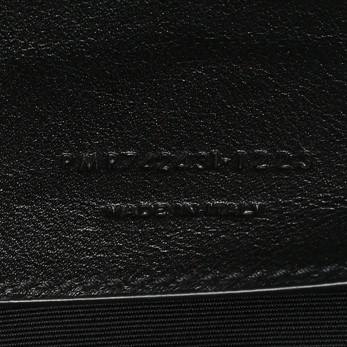 Leather brand stamp on black lining with SAINT LAURENT PARIS text