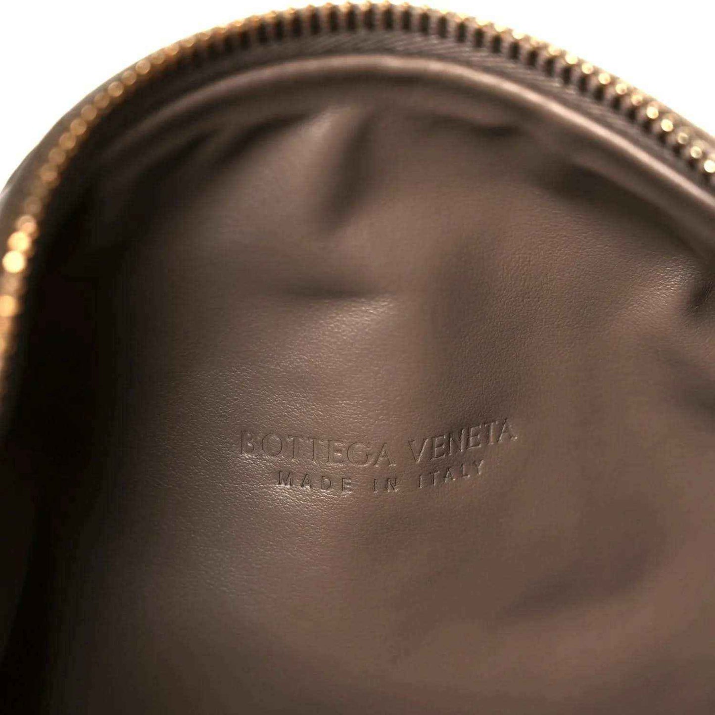 Taupe leather interior panel with embossed logo and smooth lining