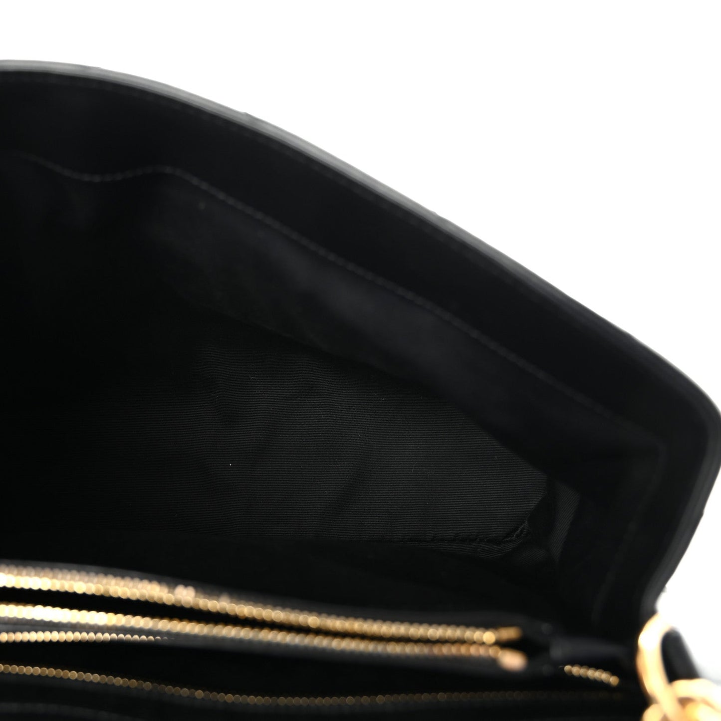 Black leather satchel interior with gold zipper trim.